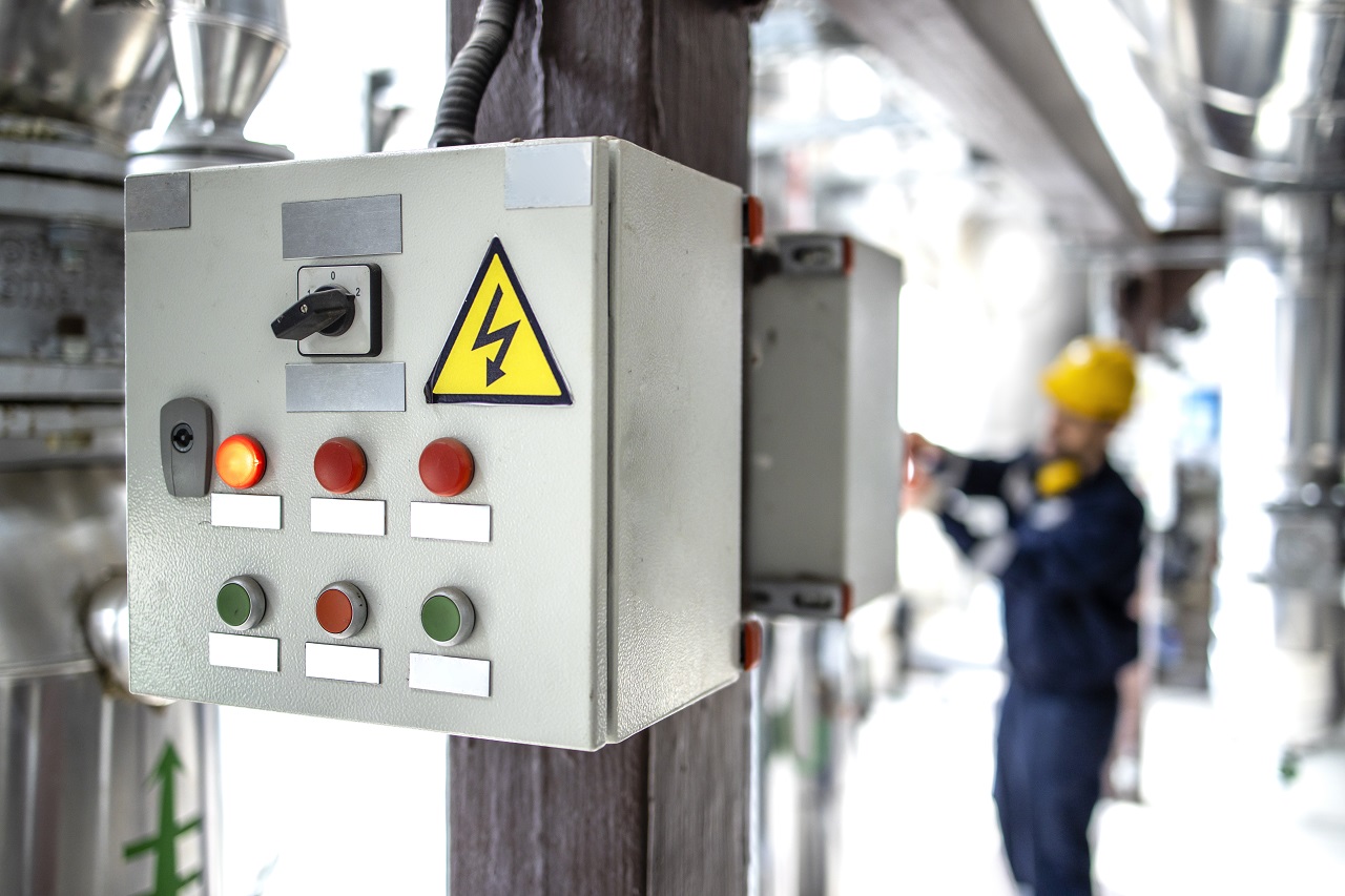 A closeup of an electrical control systems box with different buttons.