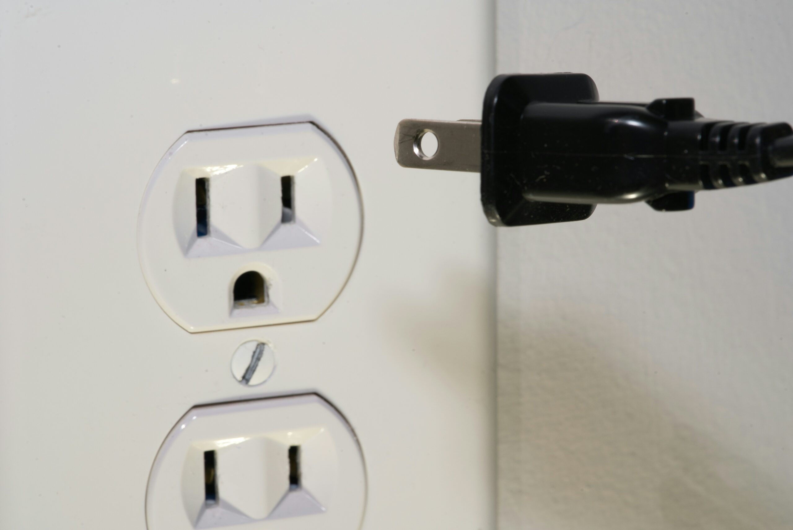 Close-up of a residential electrician installing an outlet