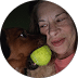 Dog and owner playing together, showcasing a joyful interaction with a green tennis ball, emphasizing companionship and fun.