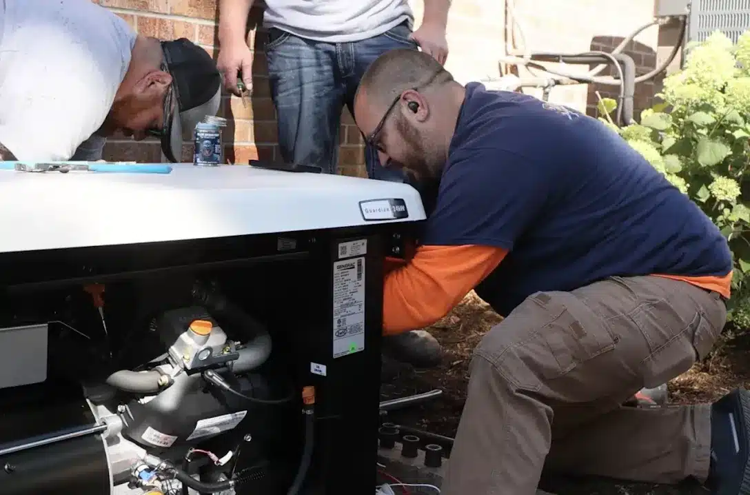 Technician performing maintenance on a home standby generator, highlighting essential services