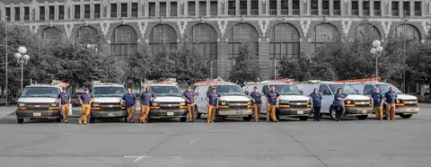 The Rewired Iowa team lined up in front of their service vans