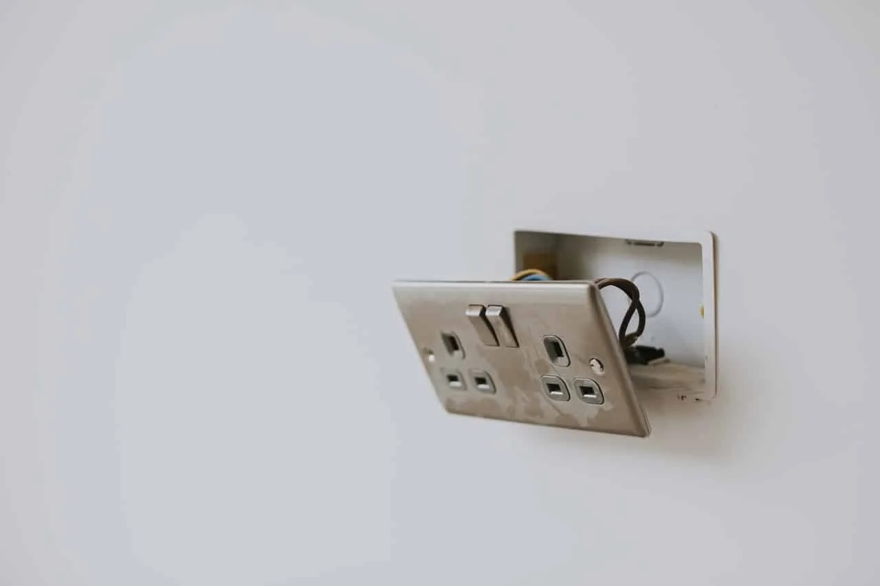 Outlet installation in a wall with exposed wiring, showcasing electrical components relevant to electrical remodeling and safety in West Des Moines, Iowa.
